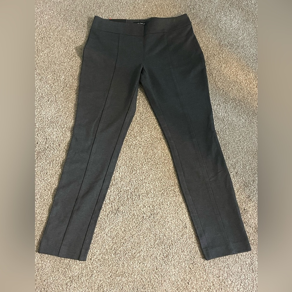 Gray, Hillary Ridley pull on pants.